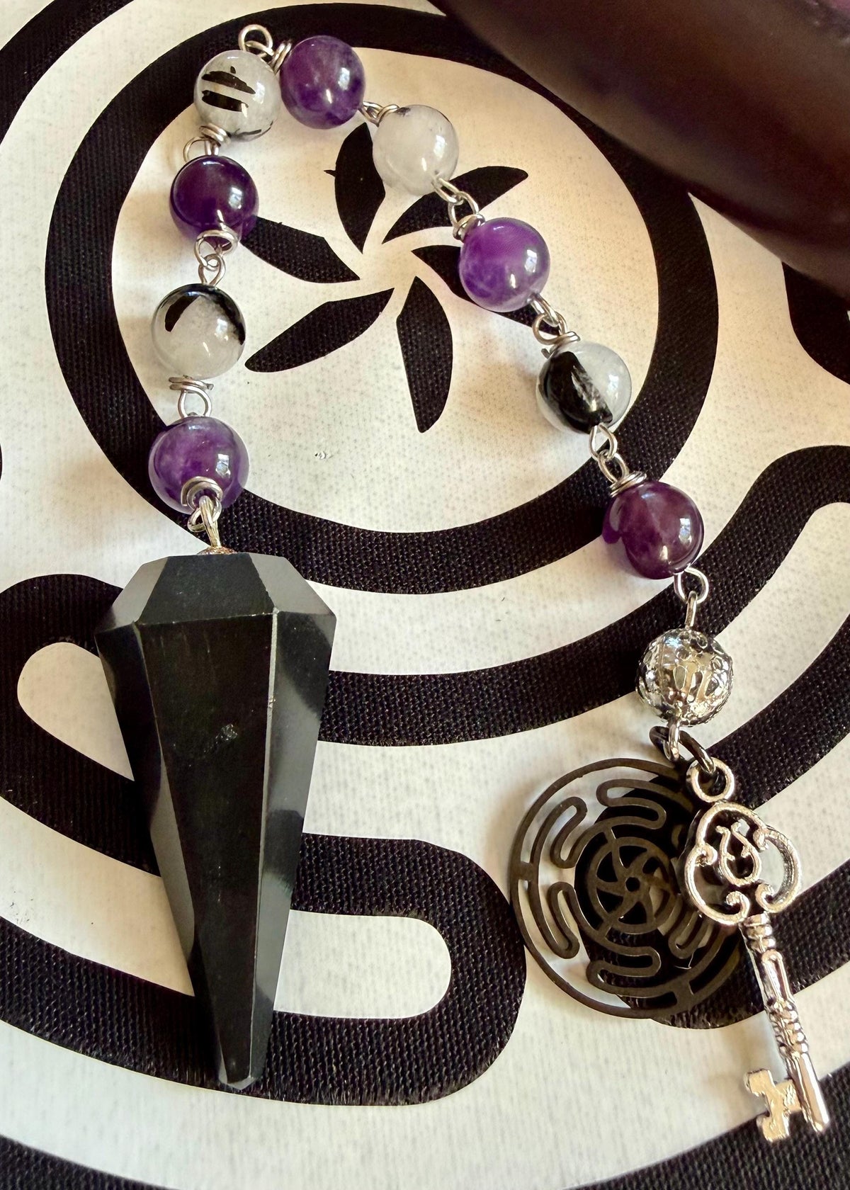 Goddess Hekate Devotional Altar Bundle with Altar Cloth, Witch’s Rosary, Pendulum , Black, and Purple Taper Candles.