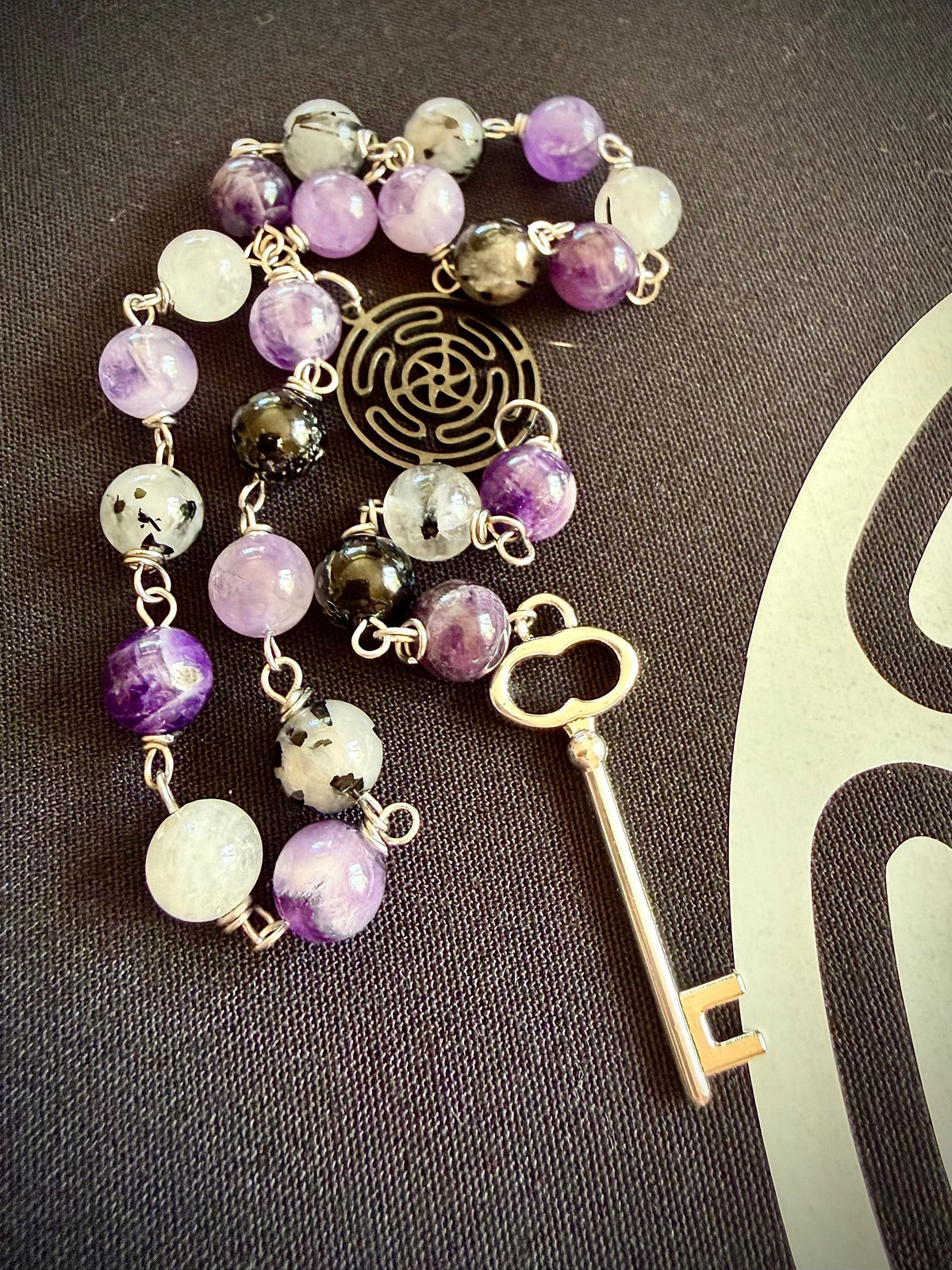 Goddess Hekate Devotional Altar Bundle with Altar Cloth, Witch’s Rosary, Pendulum , Black, and Purple Taper Candles.
