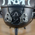 Silver tone Ouija planchette "Goodbye Yes No" dangle earrings on a black cauldron.