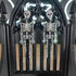 Sparkling rhinestone skeleton dangle earrings on a black gothic stand.