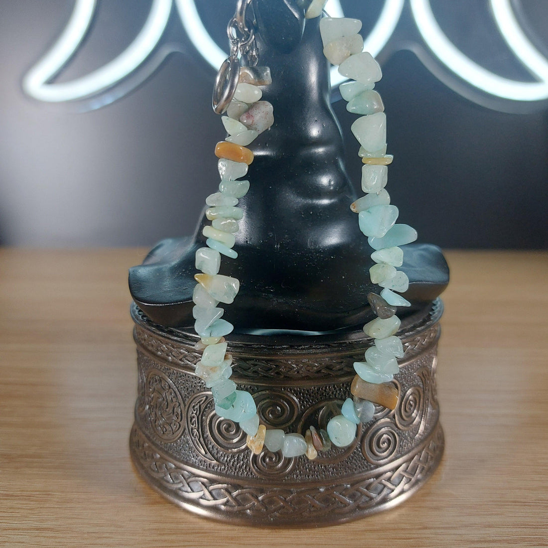 Amazonite crystal chip bracelet with stainless steel toggle, displayed on a decorative box.