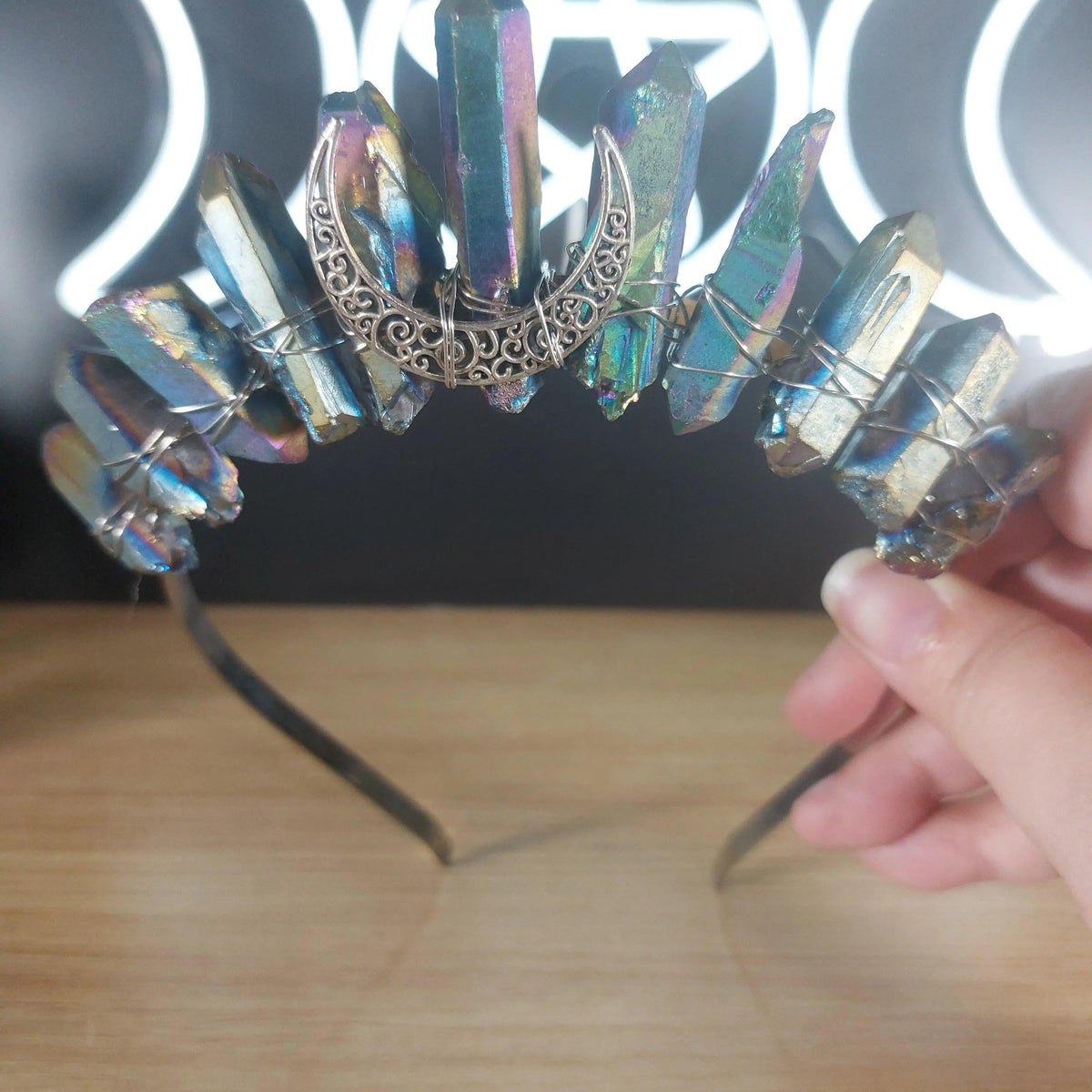 Metallic rainbow quartz crystal crown headband with a silver crescent moon accent.