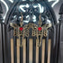 Gold tone skeleton with wings and red heart dangle earrings on a black gothic arch.