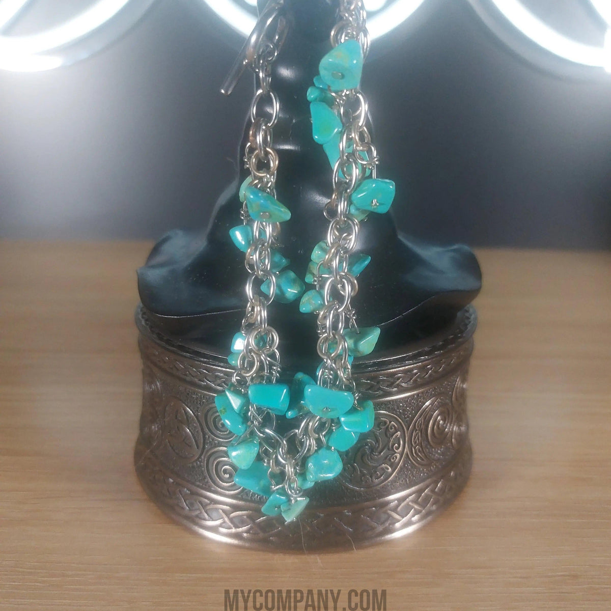 Silver stainless steel bracelet with dangling turquoise howlite gemstone chips.
