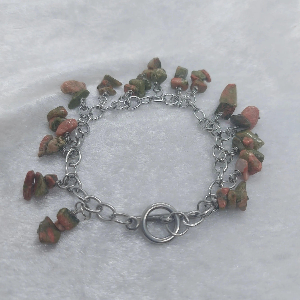 Unakite chip bracelet with green and pink stones on a stainless steel chain.