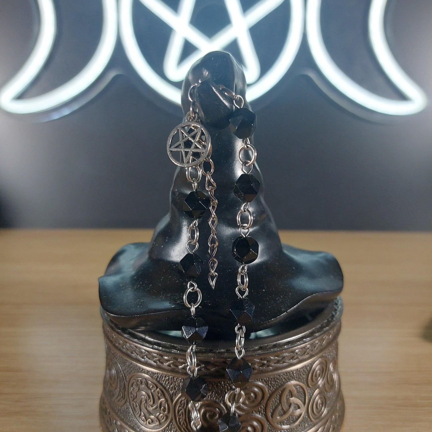 Black onyx faceted crystal bracelet with silver pentagram charm and stainless steel findings.