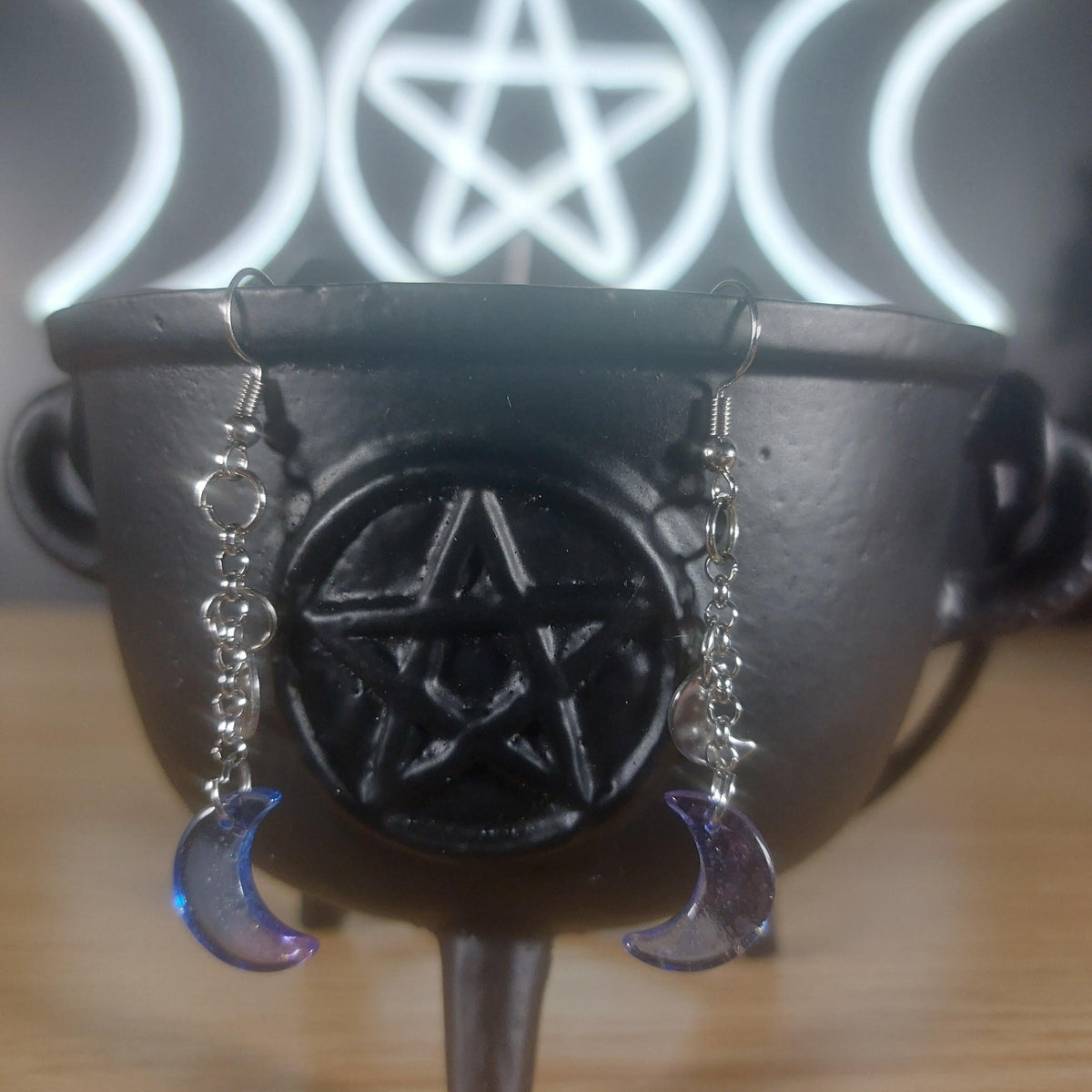 Blue/purple glass moon dangle earrings with gold specks, hanging from silver chains.