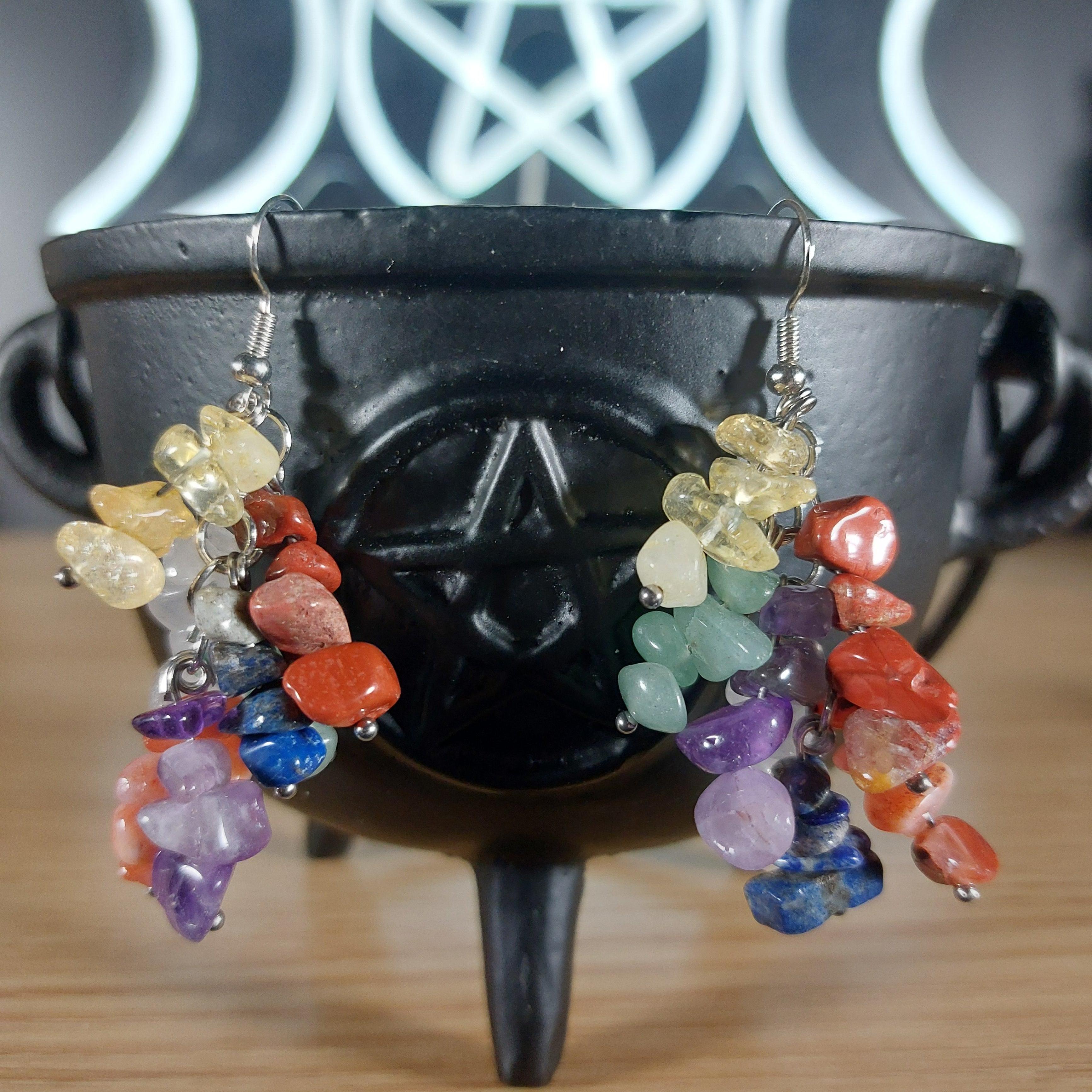 Dangle earrings with genuine chakra crystals in a rainbow of colors, featuring silver hooks.