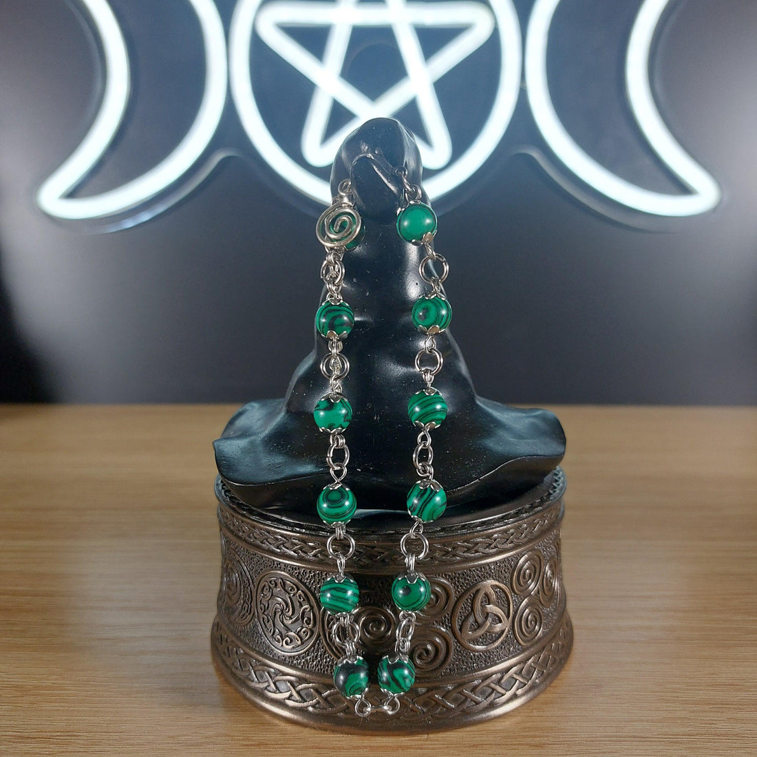 Malachite crystal beaded bracelet with stainless steel findings, bead caps, and a swirl charm.
