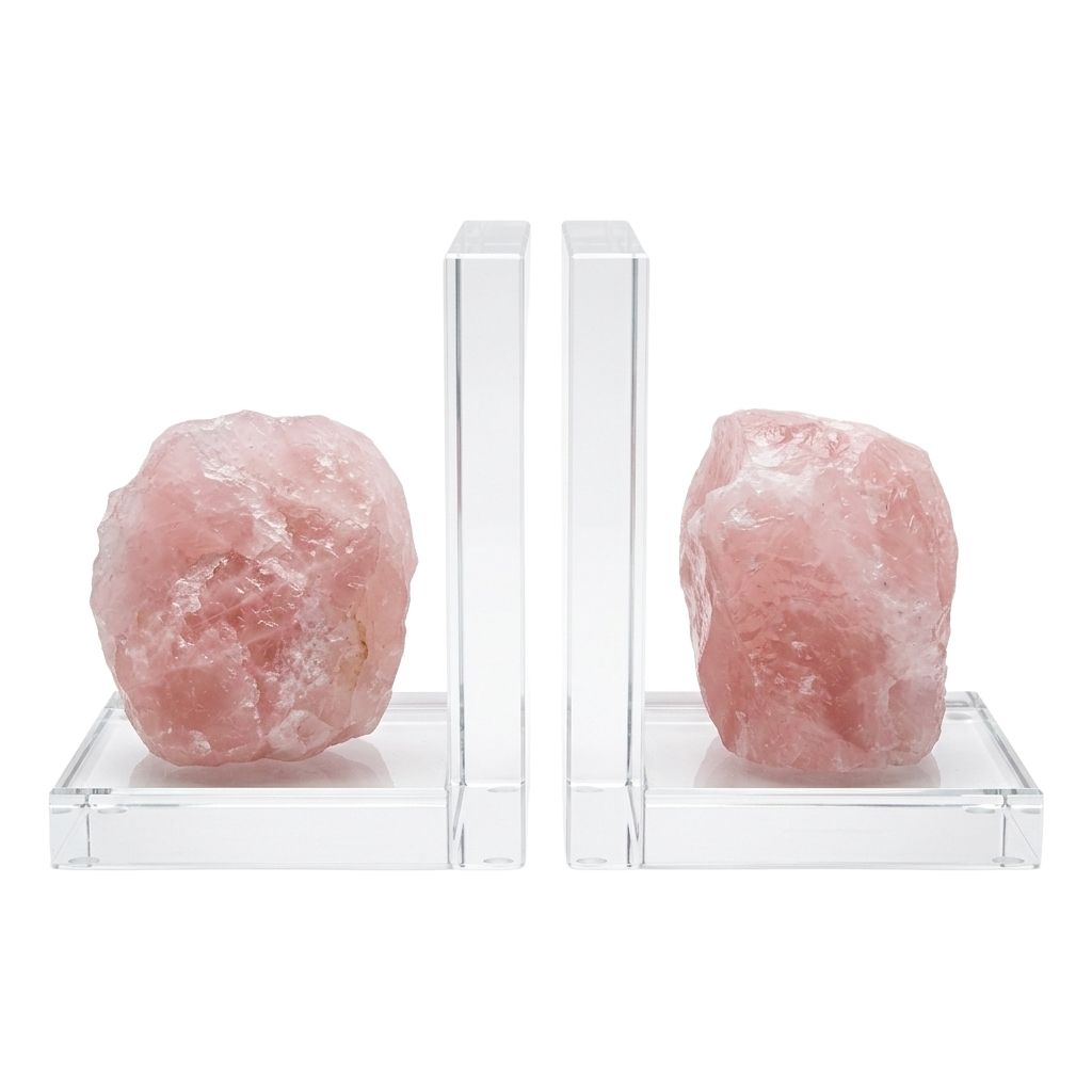 Matched set of two natural rose quartz slab bookends in soft pink with crystalline internal structure, shown propping books on plain surface